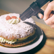 A cake facing an air gun at point-blank range